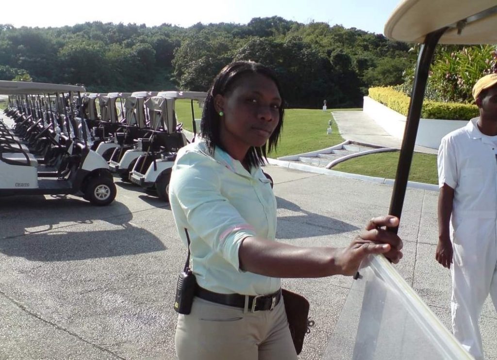 Denieve Dixonnext to a golf car.