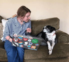 HubSpot employee with dog & laptop. 